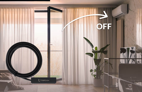 A room with an open glass door, sheer curtains, a potted plant, and a wall-mounted AC set to OFF. An arrow leads from the open door to the AC. In front are a coiled black cable labeled Blebox and an openSensor Miniature Wi-Fi Smart Open/Close Sensor by Blebox.