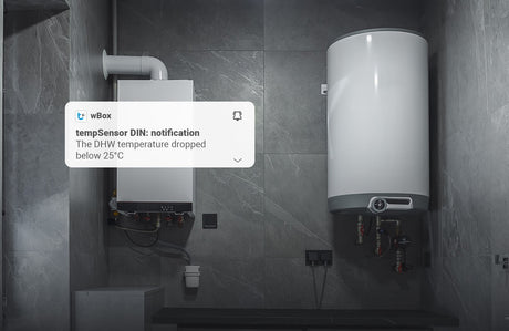A wall-mounted boiler and cylindrical water heater are in a gray tiled room. A notification says: tempSensor DIN by Blebox—DHW temperature dropped below 25°C, detected by the DIN-rail Smart Wireless Temperature Sensor for monitoring.