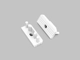 Two white plastic End Caps for the Surface10 Profile are shown on a plain gray background. Each component features cylindrical pegs, rectangular bases, geometric cutouts, and raised ridges, indicating they are designed to fit together as LED accessories.