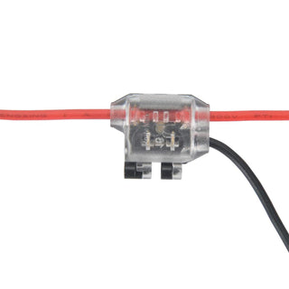The 1-Pin Y-Tap Solderless Wire Splice Connector ~ Pelican Series features a transparent housing that showcases internal metal contacts, providing secure and easy low voltage connections for red and black insulated wires.