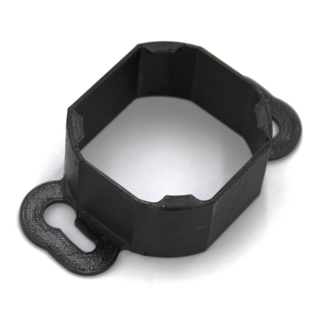 The Mounting Bracket for Casambi Smart Relay is a black, octagonal PETG bracket with two flat, rounded tabs featuring keyhole slots for secure mounting to surfaces. Ideal for use with the Casambi Smart Relay.