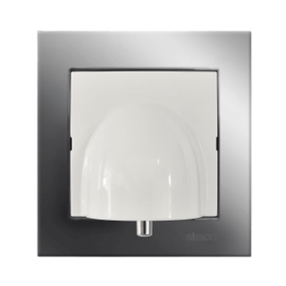 The Cable Outlet With Kontak Simon Frame ~ cableOutlet by Blebox is a smart home accessory, featuring a sleek white design mounted on a square metallic frame, seamlessly integrating cable management into your interior.