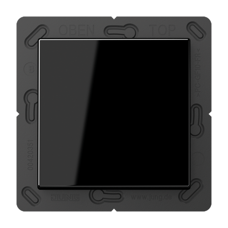 The Casambi 2-Channel Wireless Radio Transmitter (Model Jung BLE A 590) is a black, square, glossy light switch on a dark frame labeled OBEN, TOP, and a website address, featuring Bluetooth Low Energy for efficient operation.