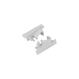 Two small, white ABS End Caps for Diagonal10 Profile with notched and grooved edges are shown on a plain white background. Perfect as corner pieces for lighting fixture installations.