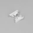 Two small, white End Caps for Diagonal10 Profile, featuring angular shapes and protruding pegs, are displayed on a plain light gray background.