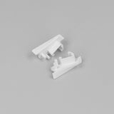 Two small, white End Caps for Diagonal10 Profile, featuring angular shapes and protruding pegs, are displayed on a plain light gray background.