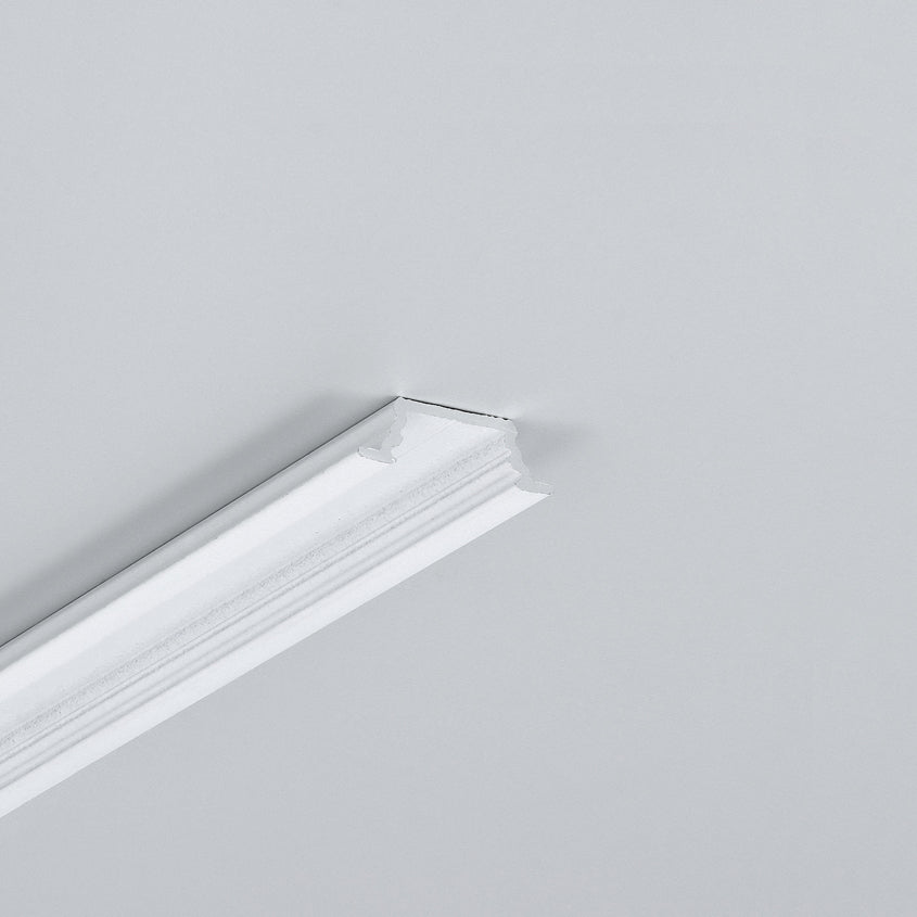 A section of white crown molding is partially attached to a plain light gray wall, with an unfinished edge visible at the top, suggesting space for installing the 0.42″ Recessed LED Channel (Model Groove10.v2) for seamless modern furniture lighting integration.