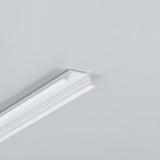 A section of white crown molding is partially attached to a plain light gray wall, with an unfinished edge visible at the top, suggesting space for installing the 0.42″ Recessed LED Channel (Model Groove10.v2) for seamless modern furniture lighting integration.