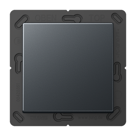 A close-up view of the Casambi 2-Channel Wireless Radio Transmitter (Model Jung BLE A 590), a square, dark light switch mechanism with energy harvesting, OPEN and TOP embossed on the frame, and a plain central button.