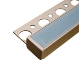 Close-up of the Tile Edge LED Strip Light Channel Kit, Model Uni-Tile12 180Deg, featuring a metal trim with large circular holes and a blue protective cover, ideal for finishing tile edges or LED installations in tiling projects.