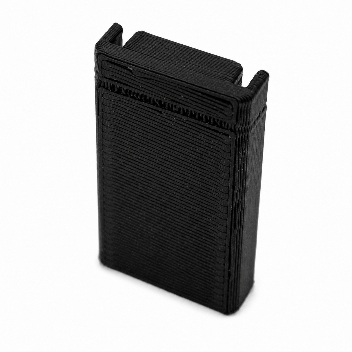 A black, rectangular Plastic End Cap for Hannover Profile made of PETG, featuring textured horizontal lines and two raised top edges, shown against a white background.