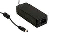 A black, rectangular Meanwell GST Series LED Desktop Adapter (24V, 60W) with a cord and cylindrical DC plug is placed on a white background.