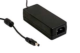 A black, rectangular Meanwell GST Series LED Desktop Adapter (24V, 60W) with a cord and cylindrical DC plug is placed on a white background.