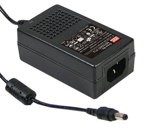 The Meanwell GST Series LED Desktop Adapter (12V) is a black power adapter with ventilation holes, a spec and safety label, and an attached barrel connector—ideal for use as an external LED driver.