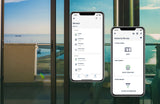 Two smartphones show the inputSensorQ by Blebox app with 4-channel smart Wi-Fi status and home automation controls, in front of a glass door overlooking a sunny seaside balcony with calm blue water.