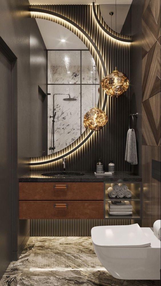 Stylish modern bathroom with curved mirror framed by warm white LED strip lights and statement pendant lighting