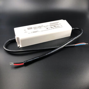 The Compact IP67 Waterproof LED Driver (24V) from the Meanwell LPV Series features a white rectangular design for outdoor use, a black cable with red, black, and blue wires, and a visible LPV-150-24 label with specifications.