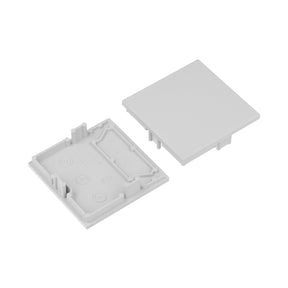 Two light gray square plastic End Caps for the Phil.v2 Profile—one reveals internal ridges and symbols, the other a smooth exterior—perfect for finishing your lighting fixture.