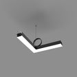 The PL55FL Modular LED Light Fixture System, with an L-shaped modern angular design in black and white acrylic and minimalist LED lines, hangs from the ceiling by two thin wires against a plain gray background.