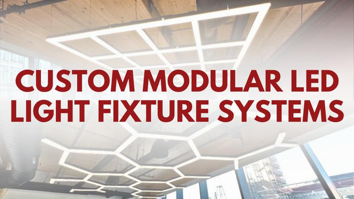 Custom modular LED light fixture systems in grid and hexagon layouts on a ceiling