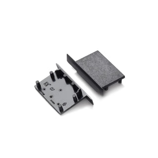 Two black plastic End Caps for Vario30-07 profile lighting fixtures are shown—one with a flat textured surface, the other with raised pegs and symbols—both placed on a plain white background.