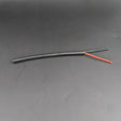 A 2-Core 18 AWG Silicone Sheathed Wire for Single Color LED Strip and Power, featuring a short black flexible cable with stripped ends showing red and black inner wires, is displayed on a plain dark background.