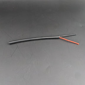 A short length of 2-Core 18 AWG Silicone Electrical Wire with red and black wires exposed against a solid dark background.