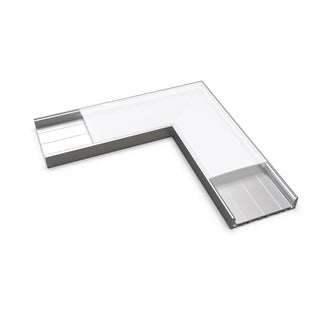 The Connector for SLW10 Profile is an L-shaped clear plastic or acrylic corner protector with a metal base, designed as a 90-degree connector to cover and protect the edges of surfaces or structures.