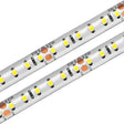 Close-up view of two parallel White High CRI IP68 LED Strip (24V) ~ Sauna Pro White Series, each featuring small yellow LEDs and electronic components mounted on a flexible white strip.