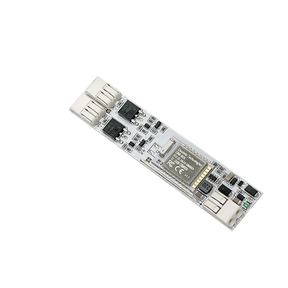 A close-up of the Compact In-channel Casambi Bluetooth Controller, a rectangular circuit board featuring chips, connectors, and RGB LEDs, set against a solid black background.