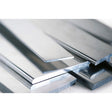 A close-up image of several shiny, flat Internal Plates for Bruselas Profile stacked together, featuring smooth, reflective surfaces and sharp edges—ideal for use as an LED channel.