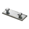 A Profile Joint for Bruselas Profile, featuring a rectangular steel plate with two hexagonal bolts and nuts at opposite corners, is displayed against a white background.