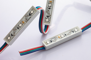 Close-up of three RGB Programmable Pixel LED Modules with exposed circuit boards and multi-colored wires, arranged on a white background—perfect for LED signage in WS2818B-compatible projects.